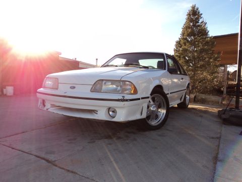 1989 Ford Mustang - Front 3/4 view of a white 1989 Ford Mustang with aftermarket wheels.