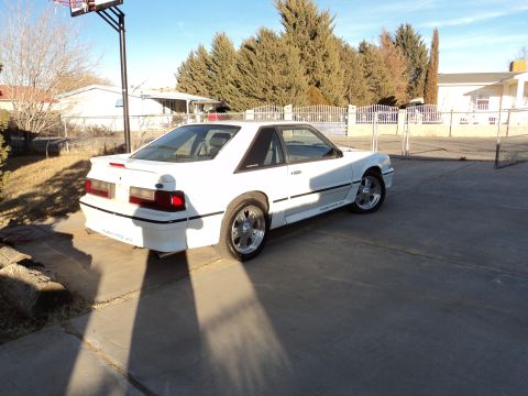 1989 Ford Mustang - White 1989 Ford Mustang GT coupe parked in a driveway.