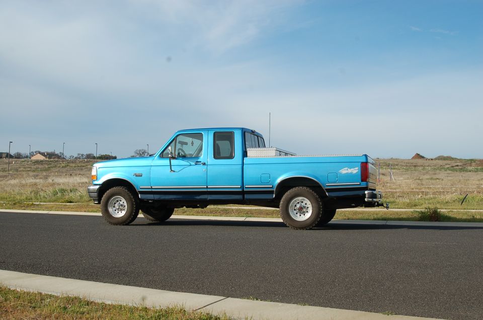 Side view of a blue 1992 Ford F-150 crew cab pickup truck