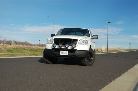 1992 Ford F-150 - White Ford F-150 truck parked on a road under a clear blue sky.