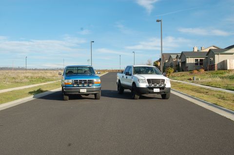 1992 Ford F-150 - Two pickup trucks are parked on a residential street under a clear blue sky.