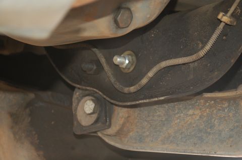 1992 Ford F-150 - Undercarriage view of a vehicle, focusing on suspension and brake lines.