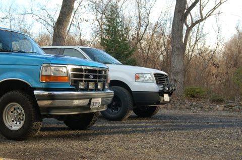 1992 Ford F-150 - Two Ford trucks, a blue F-250 and a white F-150, are parked side-by-side outdoors.