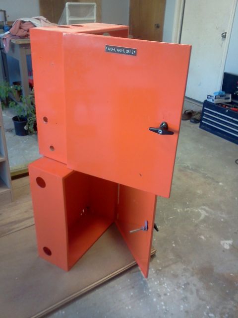 1996 Ford Bronco - Two stacked orange industrial cabinets are shown, one with its door ajar, revealing internal components.