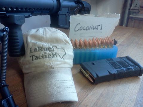 1996 Ford Bronco - A firearm, cap, and ammunition are arranged on a wooden surface.