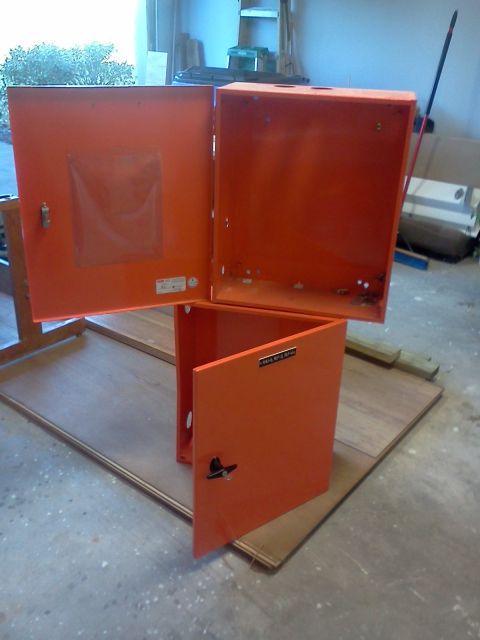 1996 Ford Bronco - Orange metal storage cabinets with doors open, placed on a wooden surface.