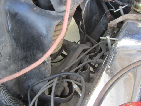 1964 Ford Ranchero - Close-up view of the engine bay in a 1964 Ford Ranchero, showing spark plug wires and various engine parts.