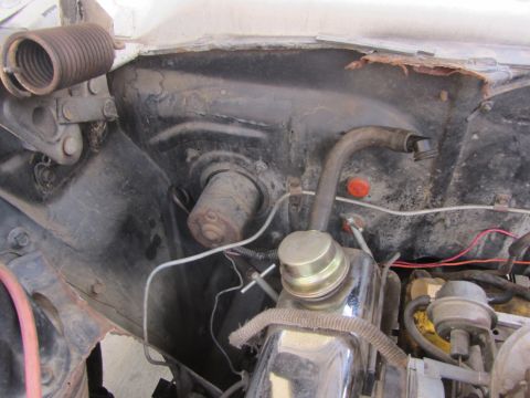 1964 Ford Ranchero - Close-up view of engine bay components including a large spring and various hoses.