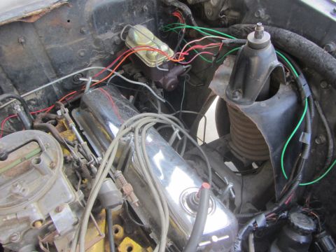 1964 Ford Ranchero - A close-up view of a vehicle's engine bay, a carburetor and various wires.