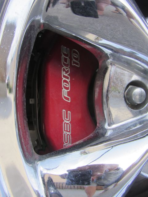 1964 Ford Ranchero - Close-up of a red brake caliper labeled "SBC FORCE 10" with chrome wheel accents.