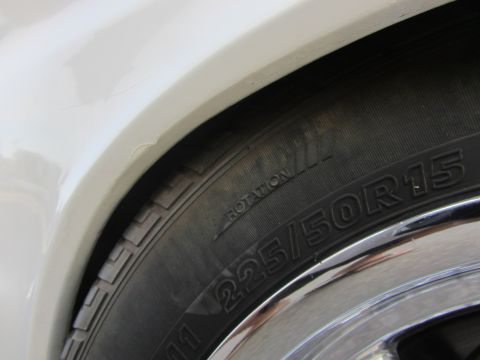 1964 Ford Ranchero - A close-up view of a tire and part of a vehicle's fender is visible.