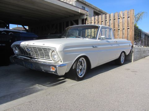 1964 Ford Ranchero - White 1963 Ford Falcon Ranchero pickup truck with chrome wheels parked under a carport.