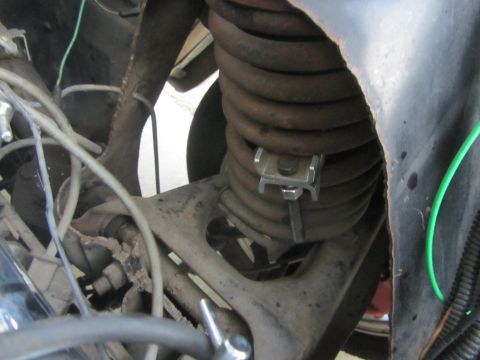 1964 Ford Ranchero - Detail of the front suspension system, focusing on the coil spring and its components.