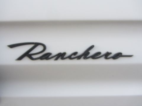 1964 Ford Ranchero - Close-up of a 'Ranchero' badge, likely from a Ford vehicle.