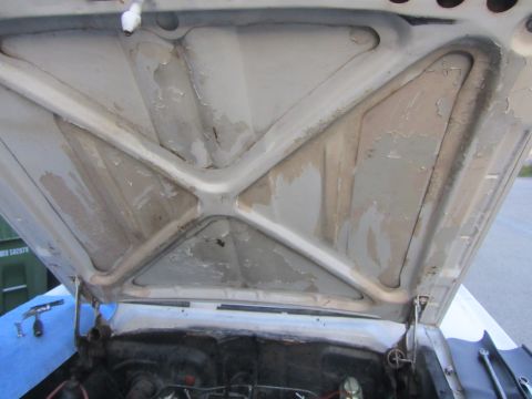 1964 Ford Ranchero - Underside of the hood on a 1964 Ford Ranchero, revealing structural bracing and signs of wear.