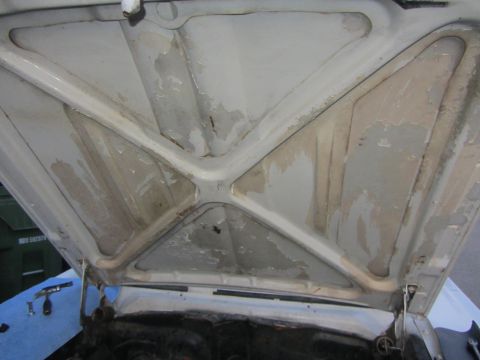 1964 Ford Ranchero - The underside of the hood shows signs of wear and tear, with peeling paint and some discoloration.
