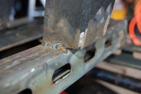 2010 Kawasaki BAYOU 220 - A close-up view of a metal frame section shows signs of rust and welding.