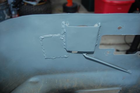 2010 Kawasaki BAYOU 220 - A close-up view of a gray, welded metal part with visible welds and cutouts.