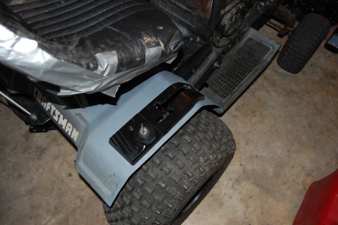 2010 Kawasaki BAYOU 220 - Craftsman lawn tractor seat and fender detail with a knobby tire visible.