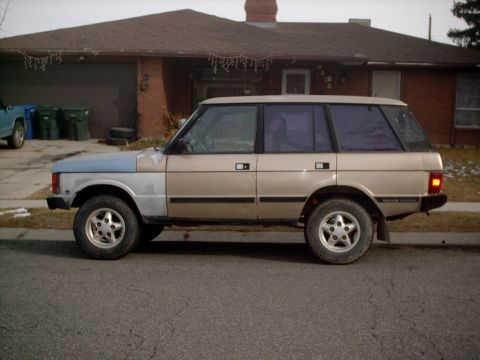 1991 Land Rover Range Rover - This 1991 Land Rover Range Rover is seen from the side, a two-tone paint scheme with tan and light blue sections.