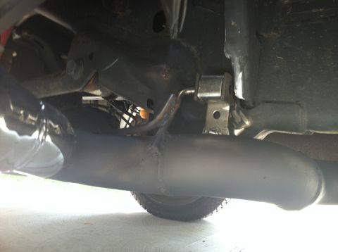 2010 Dodge 1500 - Close-up of the undercarriage, focusing on the exhaust system and suspension components.