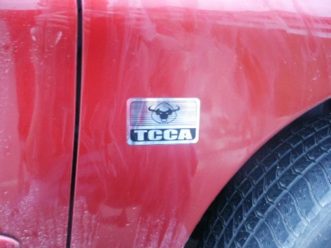 1998 Mercury Sable - Close-up of a car door a TCCA emblem with a bull's head graphic.