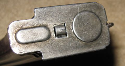 2000 Ford Crown Victoria - Metal part with distinct indentations and a central post, likely a component from machinery.