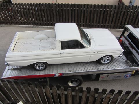 1964 Ford Ranchero - White 1964 Ford Ranchero being transported on a tow truck.