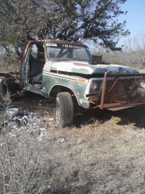 1989 Ford Bronco - This abandoned Ford F-Series truck shows significant wear and tear, with its doors removed and a makeshift metal guard on the front.