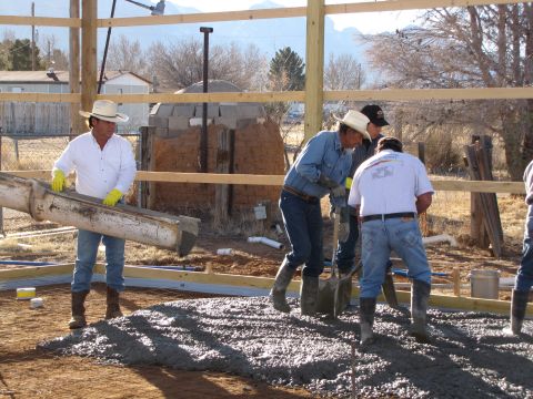 1995 Ford Bronco - Workers pour concrete for a new foundation on a construction site.