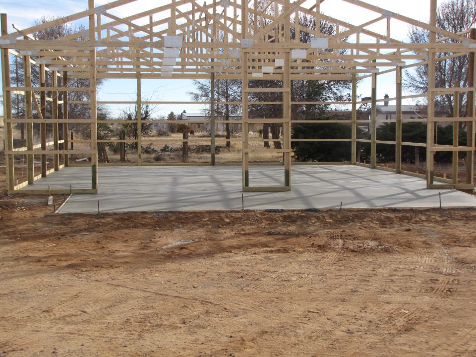 Under construction building with wooden frame and concrete floor
