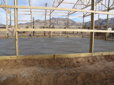 1995 Ford Bronco - A building is under construction with a concrete foundation poured and wooden framing in place.