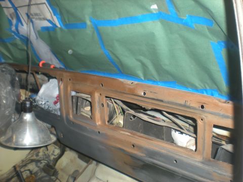 1978 Ford Bronco - The interior of a vehicle is being prepped for paint, with protective coverings and exposed wiring visible.
