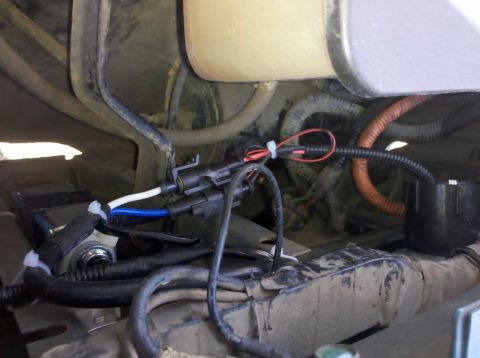 1992 Ford F-150 - Close-up view of the engine bay wiring harness, showing electrical connections and protective tubing.