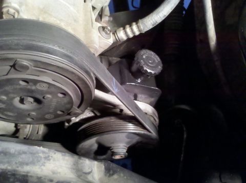 1992 Ford F-150 - Close-up view of the power steering pump and associated pulleys and belt.