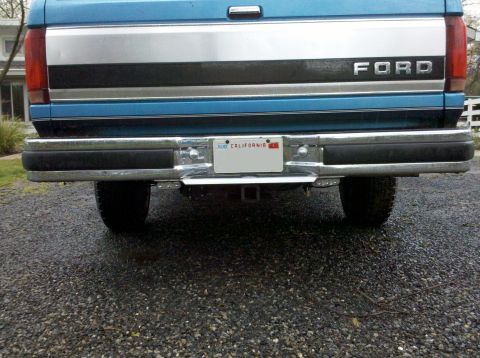 1992 Ford F-150 - Rear view of a blue Ford truck, showing the tailgate and chrome bumper with a California license plate.