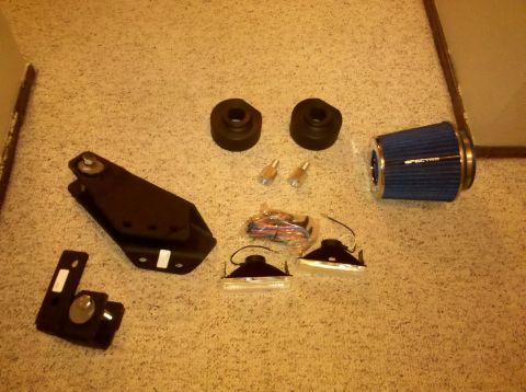 1992 Ford F-150 - Various aftermarket vehicle parts are laid out on a carpeted floor.