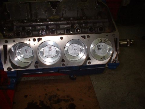 1969 Mercury Cyclone - Close-up view of an engine block's cylinders and pistons, with numerical markings on the piston tops.