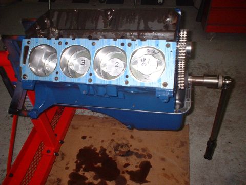 1969 Mercury Cyclone - Engine block assembly in progress, showing pistons and timing components.