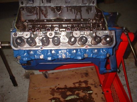 1969 Mercury Cyclone - Engine block with valve train components visible, mounted on a red engine stand.