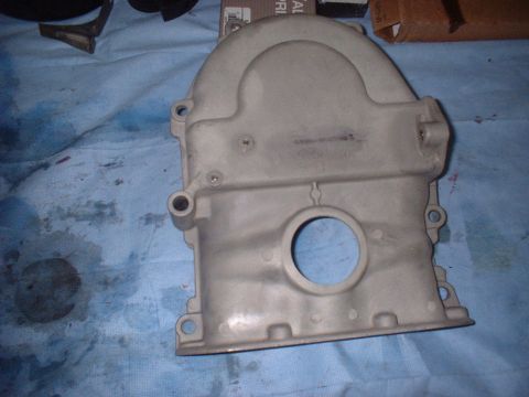 1969 Mercury Cyclone - Engine timing cover shown on a blue cloth surface.