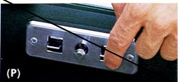 1976 Ford Ranchero - A hand operates a switch on a metal panel, part of a vehicle's interior.