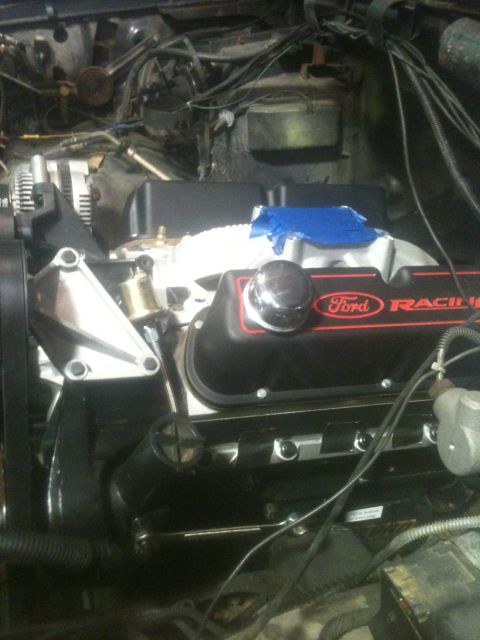 1993 Ford Bronco - Engine bay detail showing a Ford Racing valve cover and various hoses and wires.