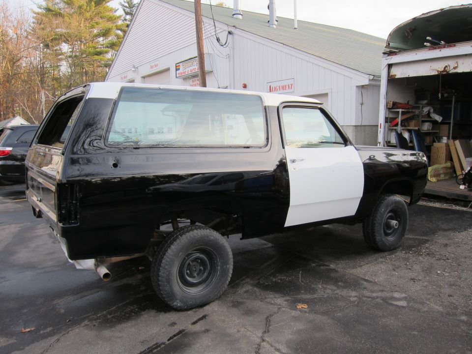 Black and white two-tone SUV, side view. 1987 Dodge 1500