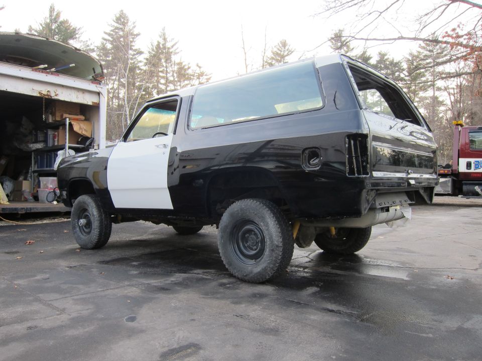 Black and white two-tone SUV, 3/4 front view. Appears to be a 1987 Dodge Ramcharger