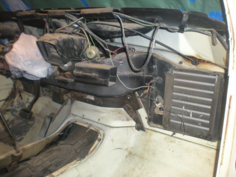 1978 Ford Bronco - The interior of a vehicle displays exposed dashboard components and wiring, with visible HVAC elements.