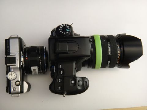 1993 Ford Taurus - Two digital cameras, an Olympus and a Sony, are placed side-by-side on a white surface.