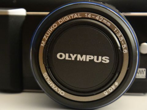 1993 Ford Taurus - Close-up of an Olympus camera lens, showing the brand and focal length specifications.