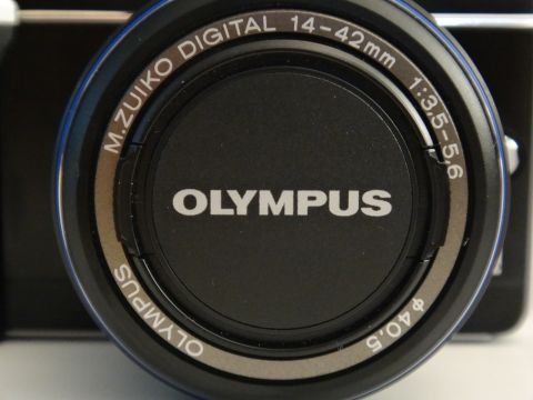 1993 Ford Taurus - This is a close-up view of an Olympus camera lens, showing brand and focal length details.