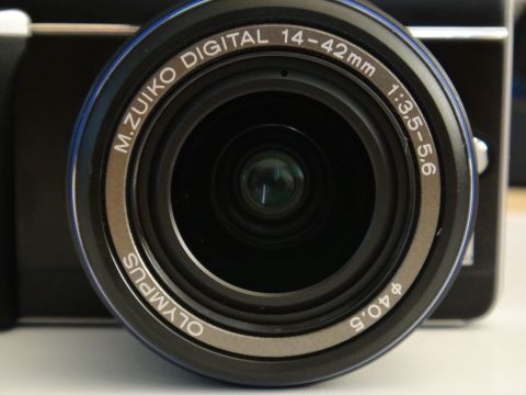 1993 Ford Taurus - Close-up of an Olympus camera lens, showing brand and specifications.